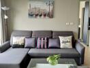 Cozy living room with gray sofa and wall art