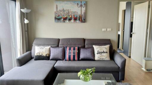 Cozy living room with gray sofa and wall art