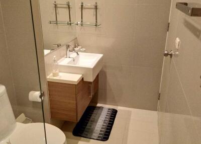 Modern bathroom with wall-mounted sink and cabinet