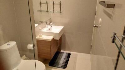 Modern bathroom with wall-mounted sink and cabinet