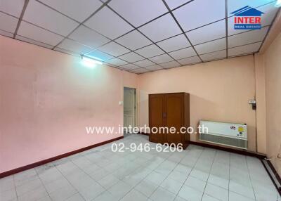 Unfurnished bedroom with pink walls and tiled floor