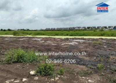 Vacant land with a view of houses in the distance