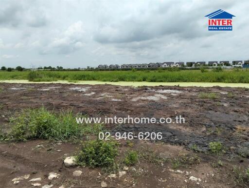 Vacant land with a view of houses in the distance