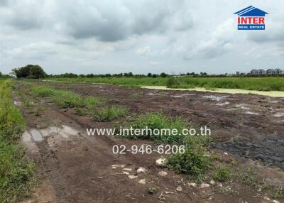 Vacant land plot with some vegetation and adjacent water body