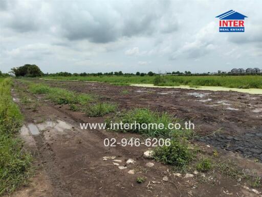 Vacant land plot with some vegetation and adjacent water body