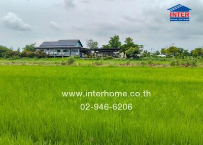 Green field with a building in the background