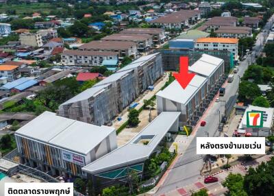 Aerial view of a commercial property with surrounding buildings and market area