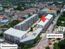 Aerial view of a commercial property with surrounding buildings and market area