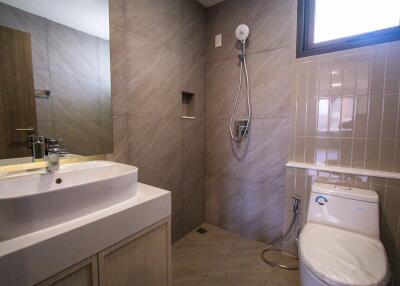 Modern bathroom with shower, sink, and toilet