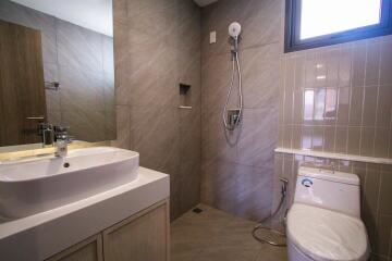 Modern bathroom with shower, sink, and toilet