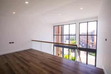 Spacious living room with large windows and wooden flooring