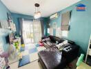 Cozy living room with blue walls, toys, and a dark sectional sofa.