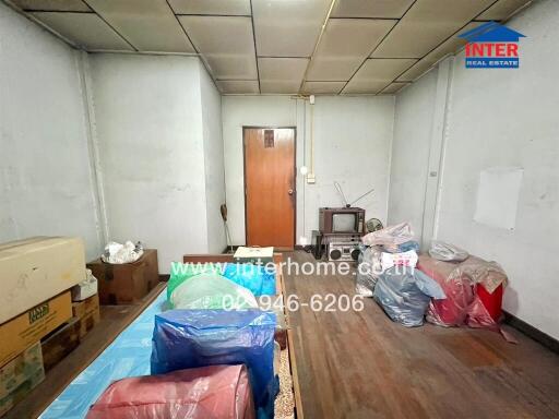 Living room with wooden floor and small TV