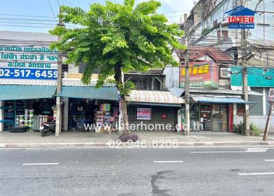 Exterior view of a commercial building with various shops