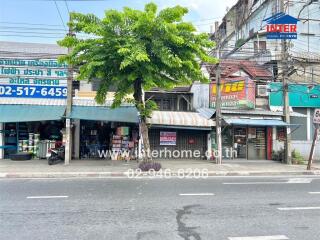 Exterior view of a commercial building with various shops