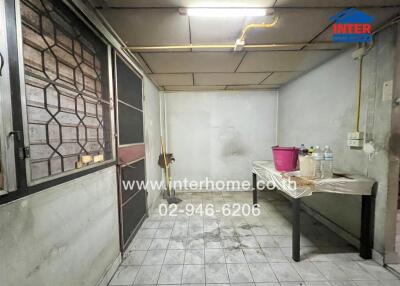 Utility room with a table and cleaning supplies