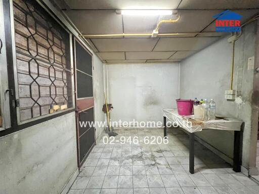 Utility room with a table and cleaning supplies