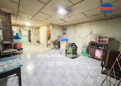 Spacious living area with tiled floor and various furniture pieces