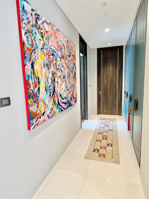 Modern hallway with colorful abstract painting and a runner rug