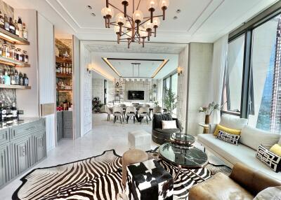 Modern living room with large windows, contemporary furniture, and a view into the dining area