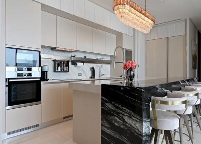 Modern kitchen with marble island and pendant lights