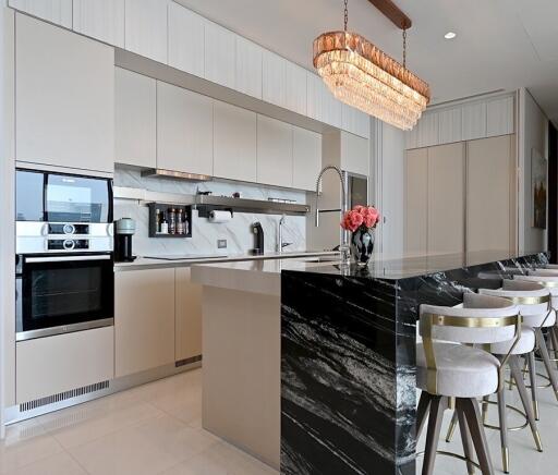 Modern kitchen with marble island and pendant lights