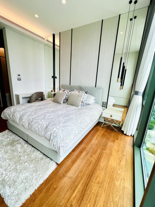 Modern bedroom with large window and hardwood floors