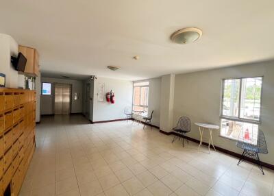 Spacious building lobby area with seating and mailboxes