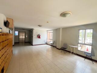 Spacious building lobby area with seating and mailboxes