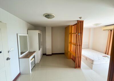 Spacious Bedroom with Wooden Partition and Attached Bathroom