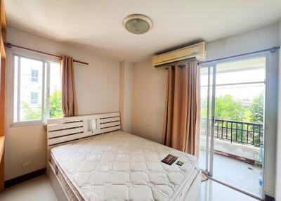 Bright bedroom with large windows and balcony access