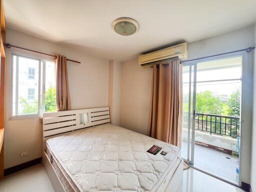 Bright bedroom with large windows and balcony access