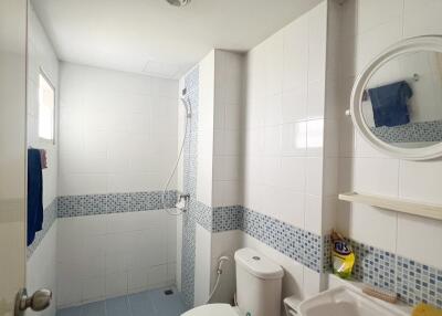 modern bathroom with shower and blue tile accents