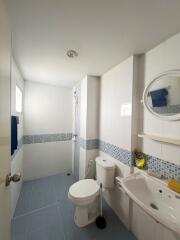 modern bathroom with shower and blue tile accents