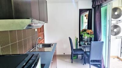 Modern kitchen area with dining set and balcony access