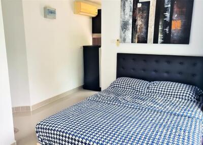 Modern bedroom with air conditioning and wall art