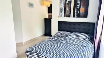 Modern bedroom with air conditioning and wall art