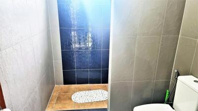 Modern bathroom with tiled walls and shower area