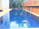 Outdoor swimming pool with mosaic tiles