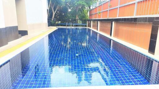 Outdoor swimming pool with mosaic tiles