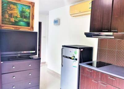 Modern kitchen with appliances and TV