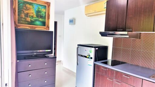 Modern kitchen with appliances and TV