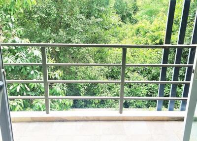 View from the balcony with lush green surroundings