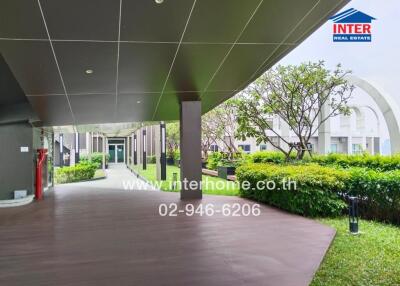 Outdoor walkway with garden and building in the background