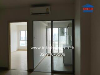 Interior view showing a room with glass doors to a balcony area