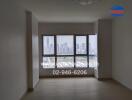 Unfurnished living room with large windows offering a city view