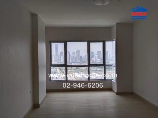 Unfurnished living room with large windows offering a city view