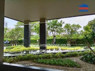 Outdoor garden area with greenery and water feature