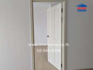 open white door in a room with wooden flooring