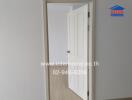 open white door in a room with wooden flooring